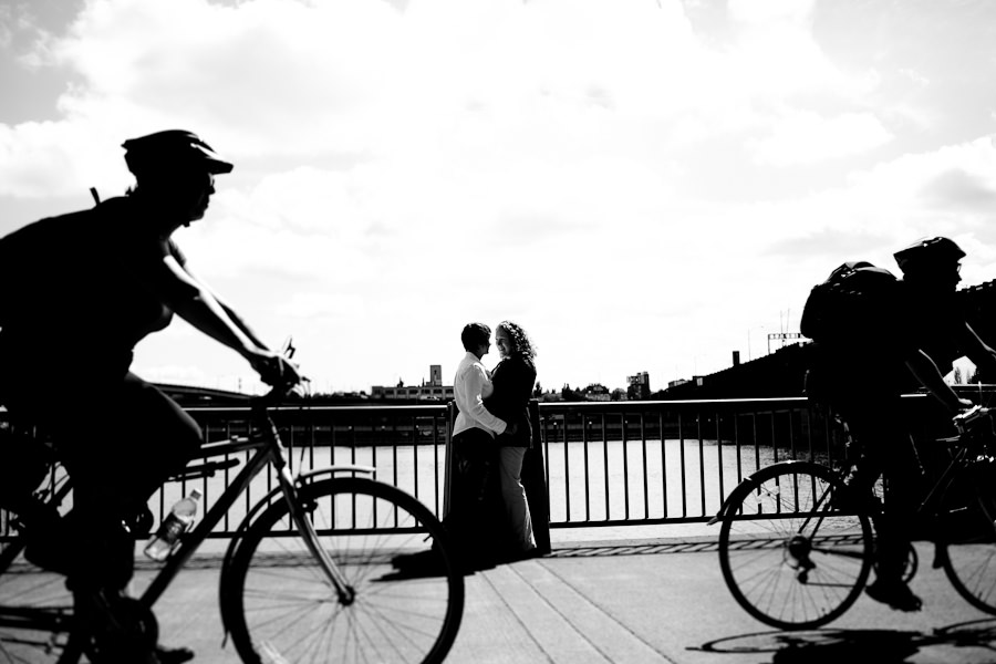 Creative photo of a couple framed in between two bikes on Portland's waterfront captured by Daniel Stark