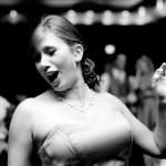 A bridemaid dances and sings at the wedding reception photographed by Portland wedding photographers, Daniel Stark.