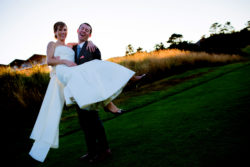 A beautiful outdoor wedding on the Oregon Coast with a sunset over the Pacific Ocean with the wedding couple.