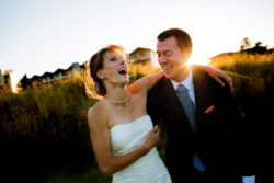 A beautiful outdoor wedding on the Oregon Coast with a sunset over the Pacific Ocean with the wedding couple.
