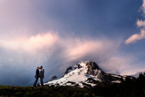 Just married grooms kiss with Mt. Hood as a backdrop