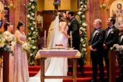 Bride and groom have their first kiss as husband and wife photographed in the breathtaking Holy Trinity Greek Orthodox Cathedral in Portland Oregon by Stark Photography.