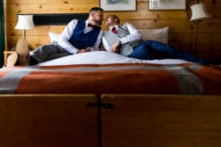 Grooms embrace in a hug after getting married at Timberline Lodge