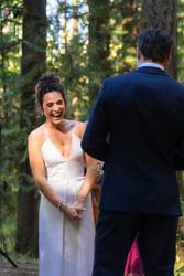 bride laughing during wedding vows at camp Colton wedding