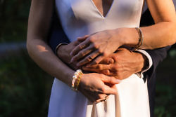 bride and groom embrace hands together