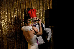 bride and groom pose in the photo booth at their Oregon wedding