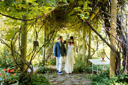 bride and groom under the arbor at mt. hood organic farms