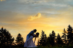 Groom dipping his bride at sunset in the Columbia Gorge