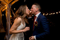 Couple takes a bite of ice cream during their Griffin House wedding reception.