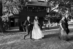 Just married couple walk in laughing to their Griffin House wedding in Oregon.