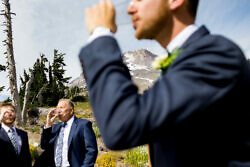 groom taking a sip of alcohol in front of mt. hood