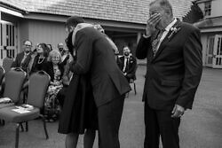 mother of the groom embraces her son at his wedding