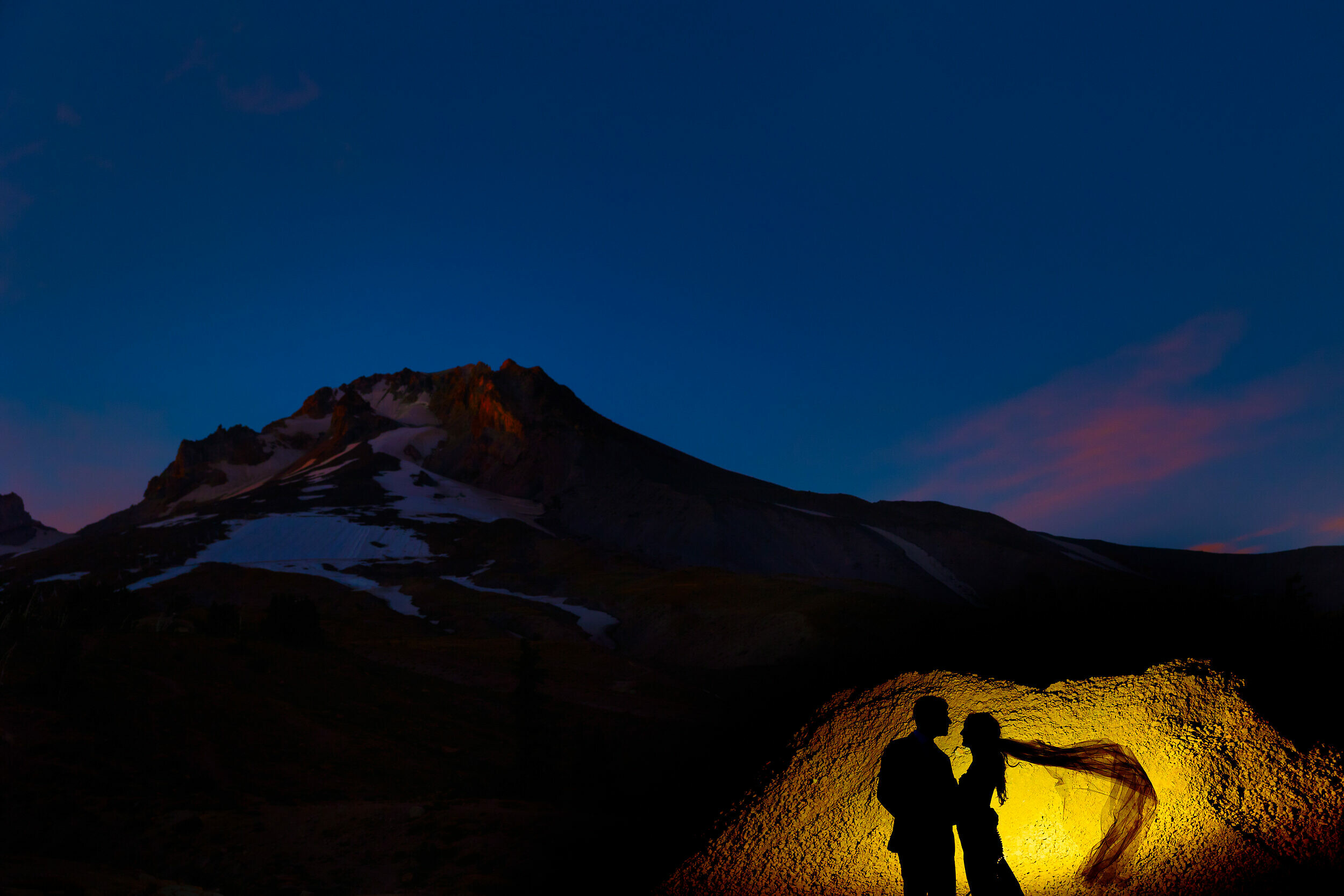 sunset silhouette of a bride and groom at mt. hood