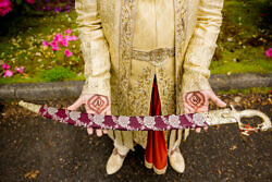 traditional Indian sword held by a groom during his baraat
