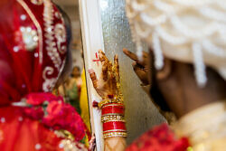 newlyweds marking their home before entering after Indian wedding ceremony