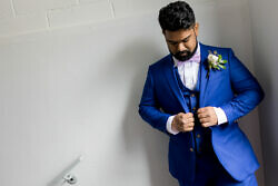groom adjusting his suit before getting married