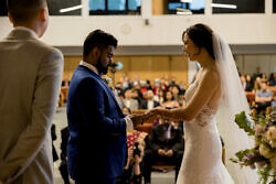 bride and groom exchange rings for catholic mien ceremony in portland