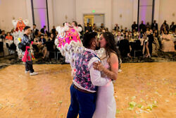 couple kisses after white lotus dragon dancers perform at a wedding in downtown portland