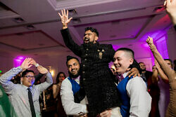groomsmen lifting the groom during his wedding reception in Portland