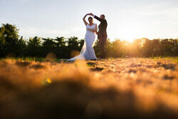 groom spinning bride in a sunset wedding photo at the orchard