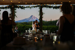 wedding couple first dance at sunset with Mt Hood in the distance