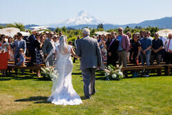 father walking bride down the aisle in front of mt hood at The Orchard wedding venue