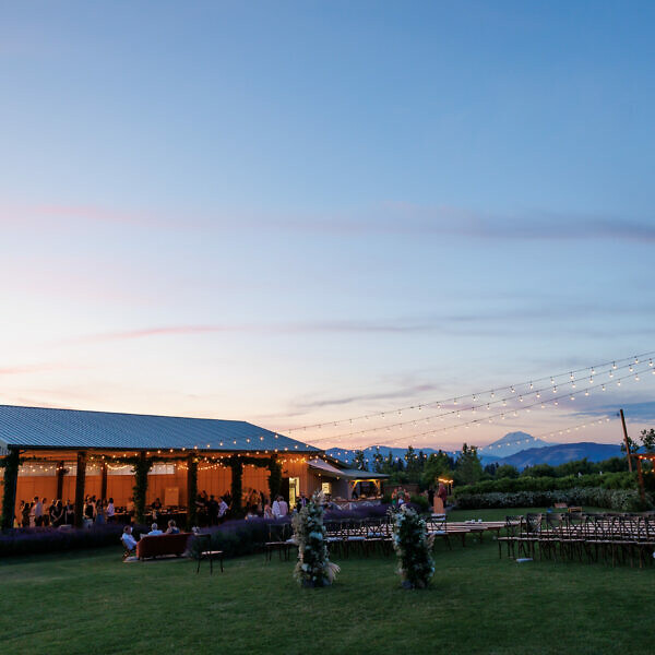 Sunset at the Hood River wedding venue The Orchard with the barn lit up